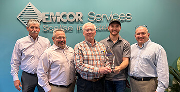 The team from EMCOR Services Scalise Industries shaking hands after winning a Safety Excellence Award